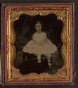 [Child in dress with pink details]