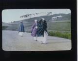 [Women walking on road]
