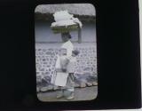 [Lower class woman carrying baby and wicker basket]