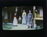 Guide Sin Song and Family (Inside court: entrance to home. Group consists of Sin Song, wife, child, and wife's sister)