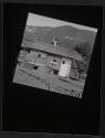[Cabin with firewood, mountains in distance]