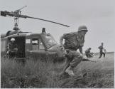 [Vietnamese woman with baby and young child, followed by a soldier]