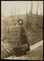 [Woman in cloak holding a banner that reads "Votes For Women Pilgrimage From New York City to Washington D.C. 1913"]
