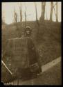 [Woman in cloak holding a banner that reads "Votes For Women Pilgrimage From New York City to Washington D.C. 1913"]