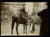 [Mounted policeman, Elisabeth Freeman petting horse]