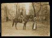 [Mounted policeman, Elisabeth Freeman petting horse]