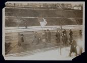 [Group of women and men walking down the street for the Suffrage Hike]
