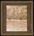 [Carriage on wet boulevard]