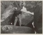 [Edward Weston standing on rocks]