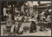 [Women selling vegetables in an outdoor market in Mexico]