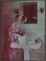 [Advertisement: woman hand-washing garment in sink]