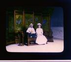 [Tourist couple seated in a photographer's studio in China]