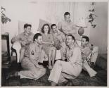 [Soldiers seated on couch and floor]