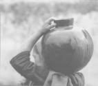 [Woman carrying waterjug]