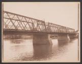 [Canoes under truss bridge]