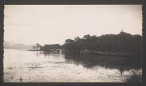 [Shore of lake with building in distance]