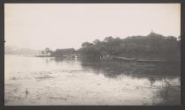 [Shore of lake with building in distance]