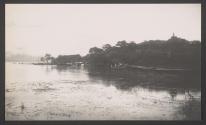 [Shore of lake with building in distance]