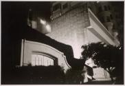 [Exterior of a tall building at night]