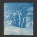 [Group of people looking at spring in a rock face]