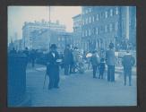 [Man with a cane walks past construction on a city street]