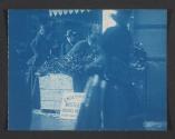 [People buying mistletoe from a street vendor]