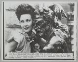 The loveliness of Anna Maria Canali of Florence, Miss Italy, emphasizes the homeliness of a Florentine statue