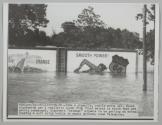 Like a gigantic, costly movie set, these signboards get a realistic touch from flood waters in which they are partly submerged