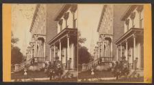 [Man seated in front of home]