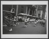 [Girls twirling hula hoops in parade]