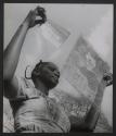 A young woman in a studio photography program, Benin (formerly Dahomey, French West Africa)