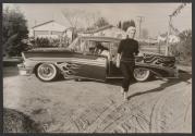 [Tuesday Weld walking away from car with flame graphics, Hollywood]