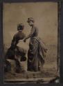 [Two women, backs facing camera]