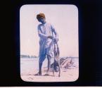 Burning Ghat, Agra, India [9] (Hindu boy casting body of infant in the Jumna river, standing in front of fire that is consuming the body of a man).