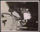 [Man carrying a cardboard box]