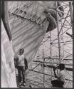 [Men on scaffolding on the Statue of Liberty]