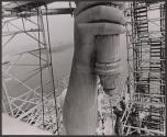 [People on scaffolding around the Statue of Liberty]