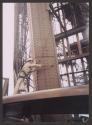 [A worker painting the Eiffel Tower]