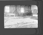 [Interior of a hanger with aircraft parts on the floor]