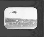 [The Collier aircraft in flight over the camp]