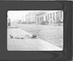 [Person lying in street]