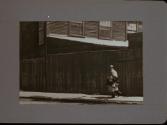 People Walking Against Building